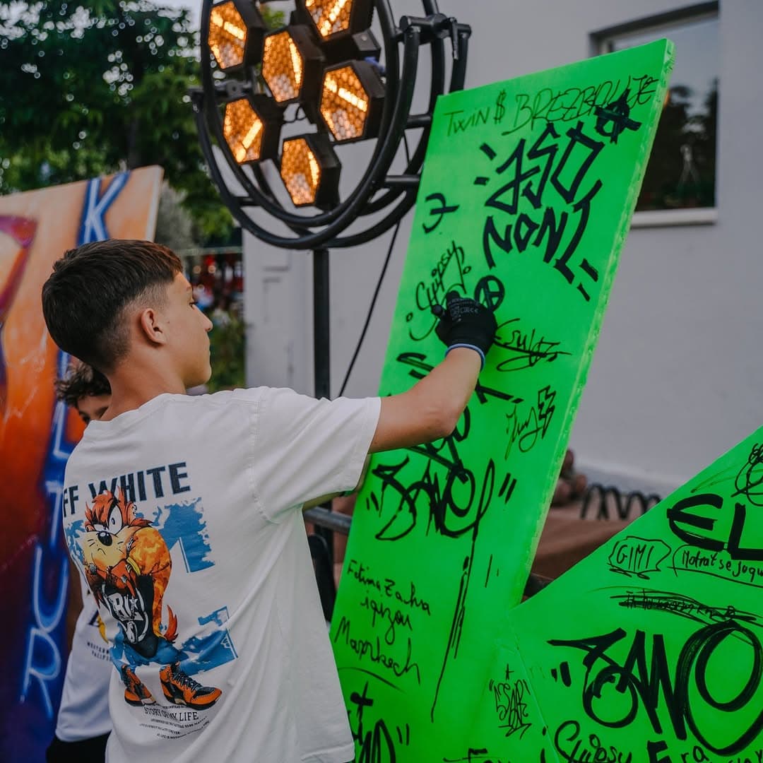 Artist painting a neon green work