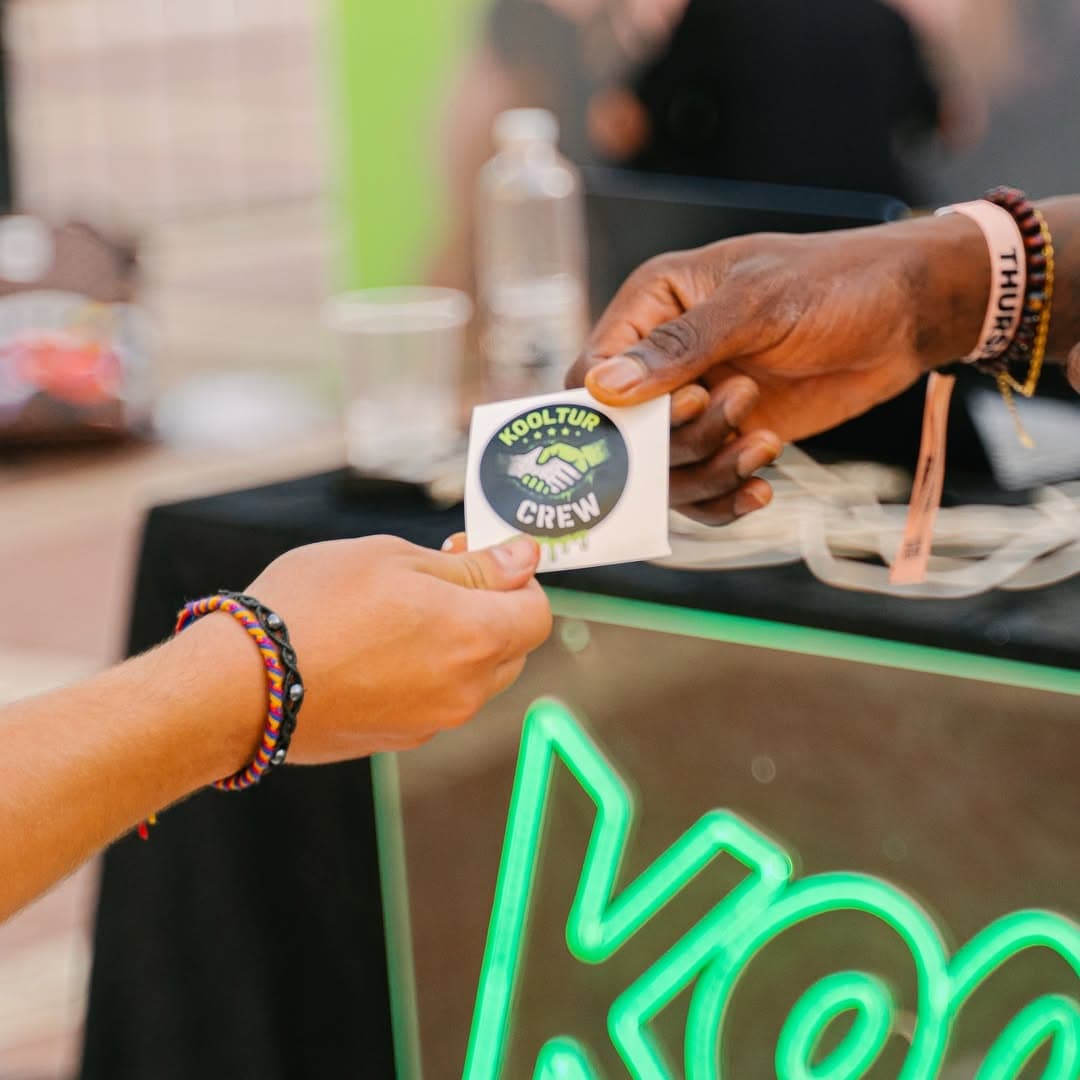 Artists embracing beside a mural